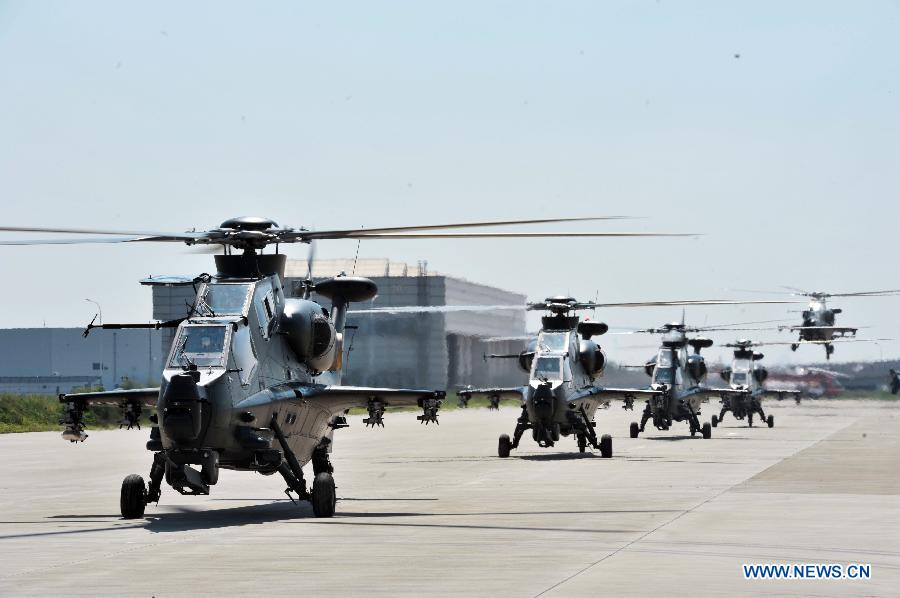 Gunships practise taking-off for the coming China Helicopter Exposition at a helicopter base of Aviation Industry Corporation of China in the Airport Area of China Pilot Free Trade Zone of Tianjin, north China, Sept. 7, 2015. 