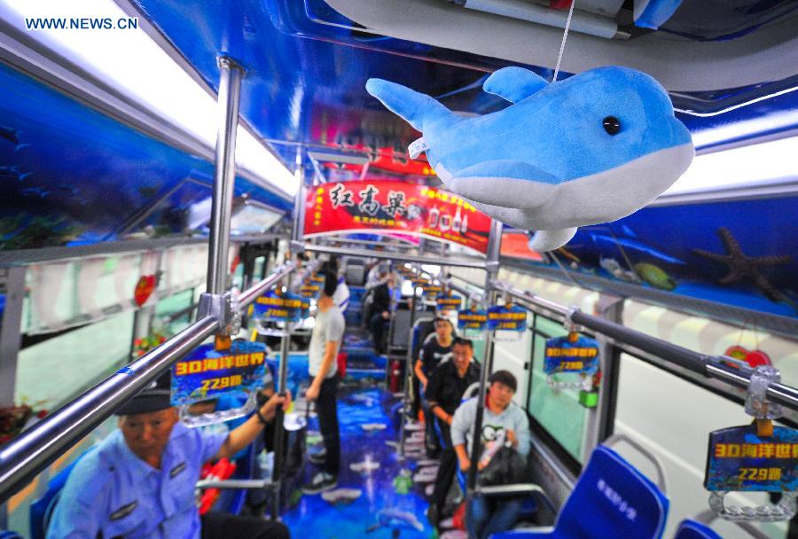 Passengers take an ocean theme bus in Changchun, northeast China's Jilin Province, Sept. 14, 2015.