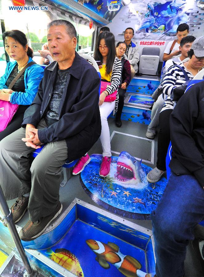 Passengers take an ocean theme bus in Changchun, northeast China's Jilin Province, Sept. 14, 2015. 