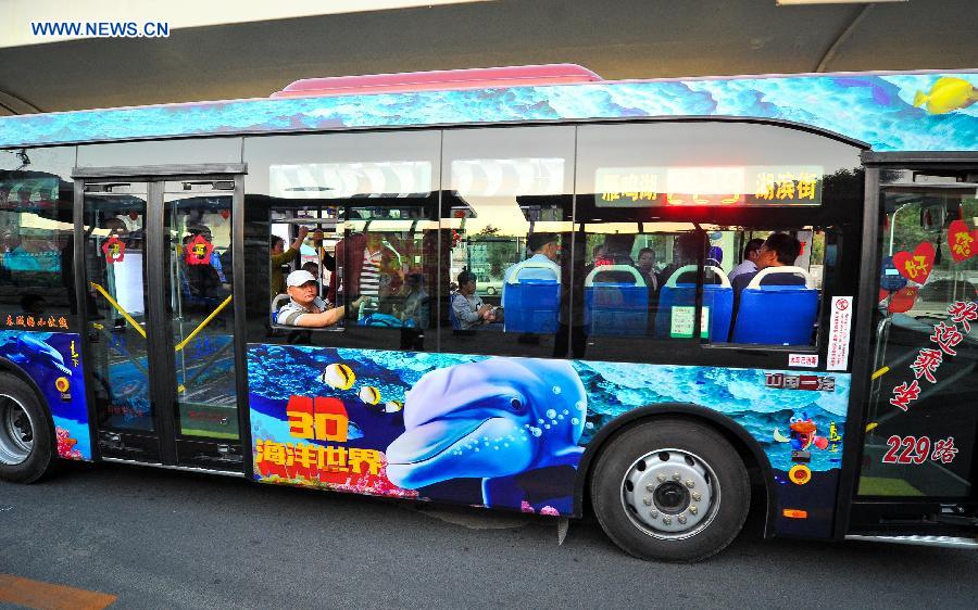 Passengers take an ocean theme bus in Changchun, northeast China's Jilin Province, Sept. 14, 2015. 