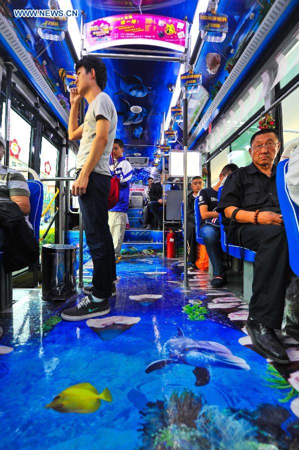 Passengers take an ocean theme bus in Changchun, northeast China's Jilin Province, Sept. 14, 2015.