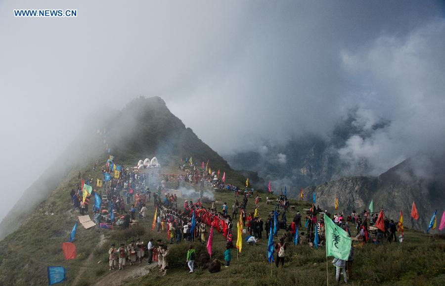 People of Qiang ethnic group worship the god 'Baihaha' in Xishan Village of Lixian County, southwest China's Sichuan Province, Sept. 20, 2015. 