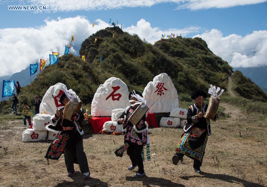 People of Qiang ethnic group worship the god 'Baihaha' in Xishan Village of Lixian County, southwest China's Sichuan Province, Sept. 20, 2015.