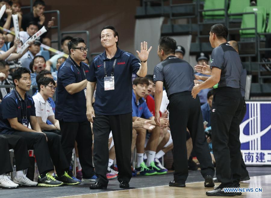 Kim Dong Kwang, head coach of South Korea, shows his dissatisfaction to the referees during the preliminary round Group C match against China at 2015 FIBA Asia Championship in Changsha, capital of central China's Hunan Province, Sept. 24, 2015. 