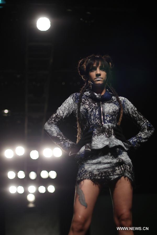 A model presents a creation of Brazilian students, made with textiles from exhibitors, during the GO TEX Show: Textile Products Trade International Fair, in Sao Paulo, Brazil, on Sept. 29, 2015. 