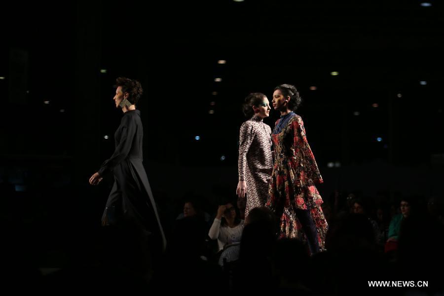 A model presents a creation of Brazilian students, made with textiles from exhibitors, during the GO TEX Show: Textile Products Trade International Fair, in Sao Paulo, Brazil, on Sept. 29, 2015. 