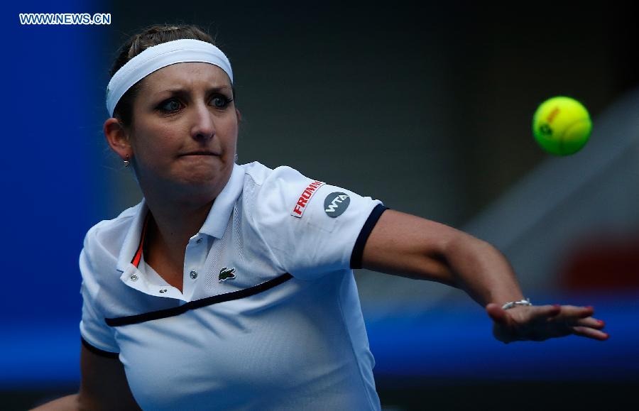 Timea Bacsinszky of Switzerland hits a return to Ana Ivanovic of Serbia during the women's singles semifinal at 2015 China Open Tennis Tournament in Beijing, China, Oct. 10, 2015.