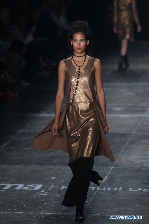 A model presents a creation of the winter collection by 'Uma Raquel Davidowicz', during the Sao Paulo Fashion Week, in Sao Paulo, Brazil, on Oct. 19, 2015. 