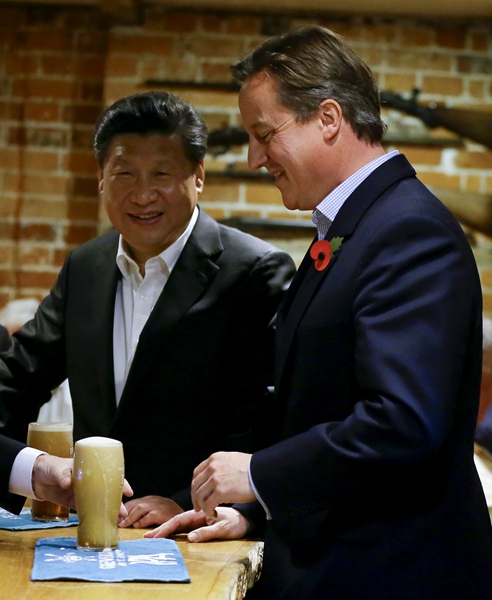 Cameron treats President Xi to beer, fish and chips in English pub