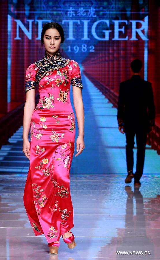 Models present creations by NE TIGER Haute Couture 2015 collection with the theme 'Qipao' during the opening show for the China Fashion Week in Beijing, capital of China, Oct. 25, 2015.