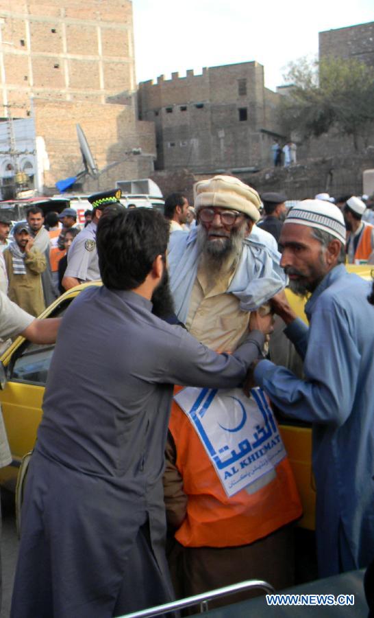 Pakistani people transfer an injured man to a hospital after a severe earthquake in northwest Pakistan's Peshawar on Oct. 26, 2015.