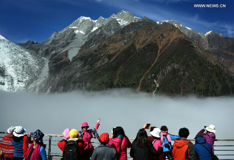 Tourists take photos in Hailuogou National Glacier Forest Park in southwest China's Sichuan Province, Oct. 28, 2015.