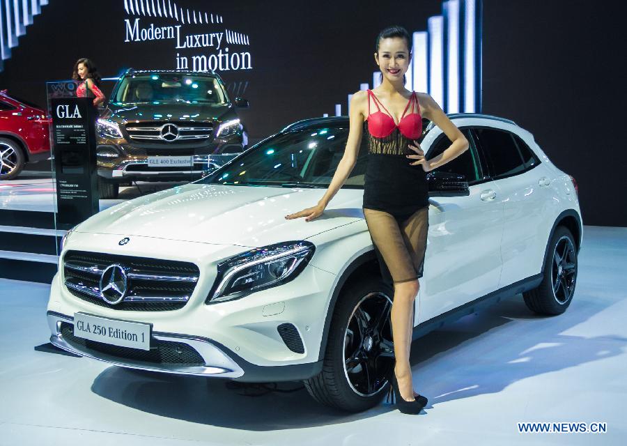 A model presents a car during the Vietnam Motor Show 2015 at Saigon Exhibition and Convention Centre in Ho Chi Minh city, Vietnam, Oct. 28, 2015.