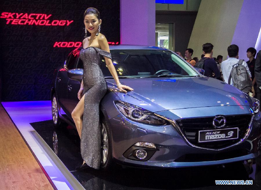 A model presents a car during the Vietnam Motor Show 2015 at Saigon Exhibition and Convention Centre in Ho Chi Minh city, Vietnam, Oct. 28, 2015.
