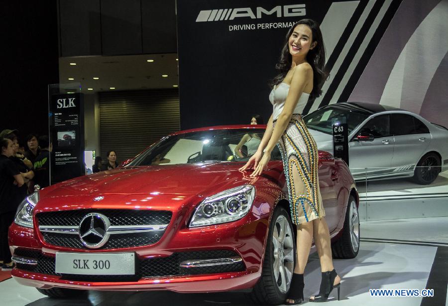 A model presents a car during the Vietnam Motor Show 2015 at Saigon Exhibition and Convention Centre in Ho Chi Minh city, Vietnam, Oct. 28, 2015.