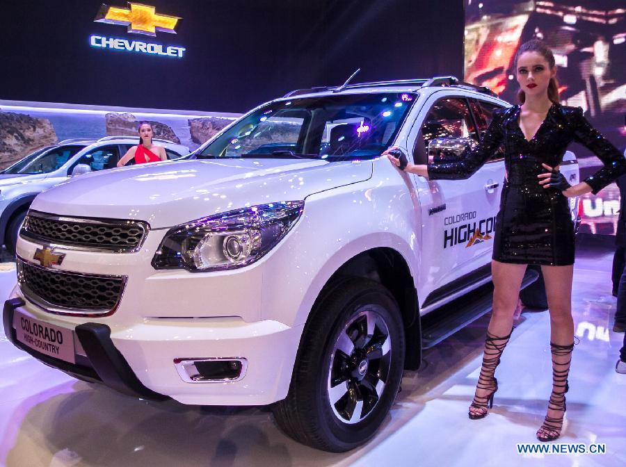 A model presents a car during the Vietnam Motor Show 2015 at Saigon Exhibition and Convention Centre in Ho Chi Minh city, Vietnam, Oct. 28, 2015.