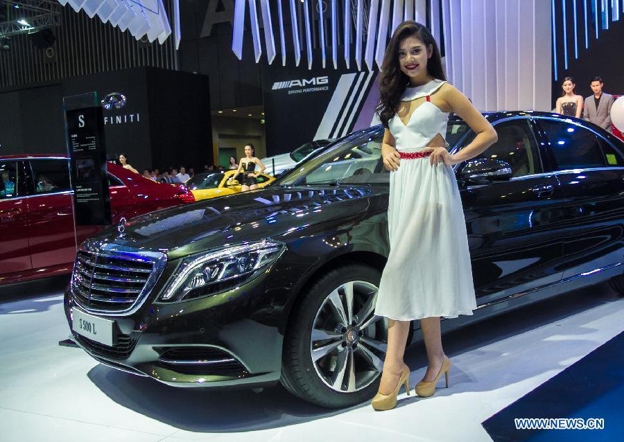 A model presents a car during the Vietnam Motor Show 2015 at Saigon Exhibition and Convention Centre in Ho Chi Minh city, Vietnam, Oct. 28, 2015.