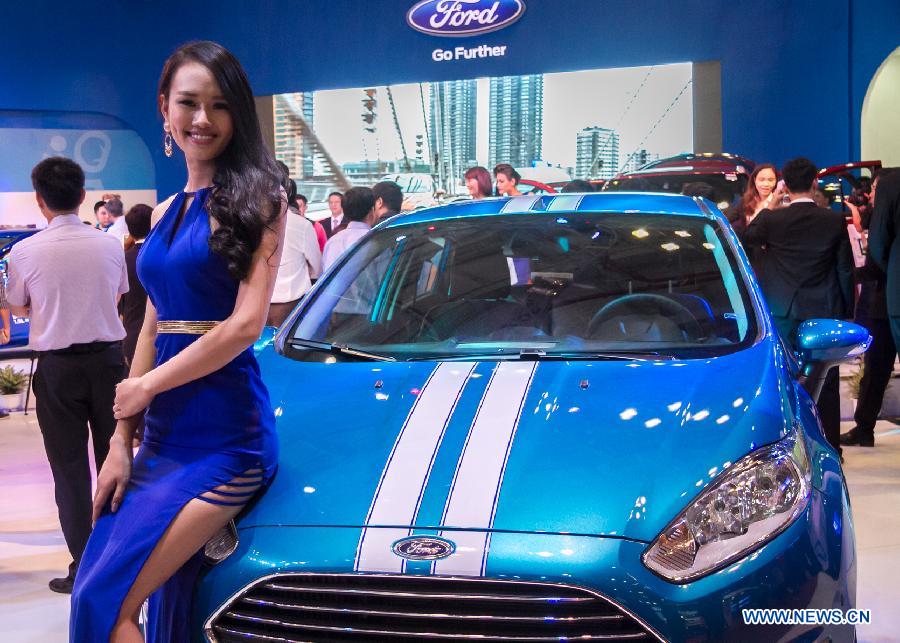 A model presents a car during the Vietnam Motor Show 2015 at Saigon Exhibition and Convention Centre in Ho Chi Minh city, Vietnam, Oct. 28, 2015.