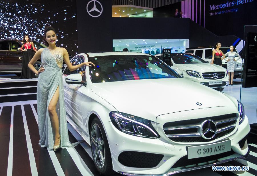 A model presents a car during the Vietnam Motor Show 2015 at Saigon Exhibition and Convention Centre in Ho Chi Minh city, Vietnam, Oct. 28, 2015.