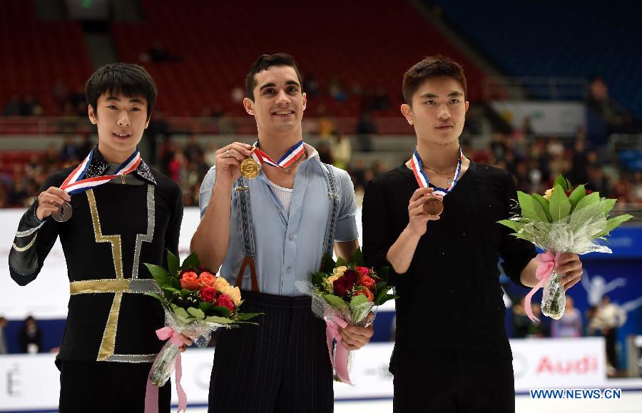 Gold medalist Javier Fernandez (C) of Spain, silver medalist Jin Boyang (L) of China and bronze medalist Yan Han of China pose during the awarding ceremony of the men's category at the 2015 Audi Cup ISU Grand Prix of Figure Skating in Beijing, capital of China, on Nov. 7, 2015.  