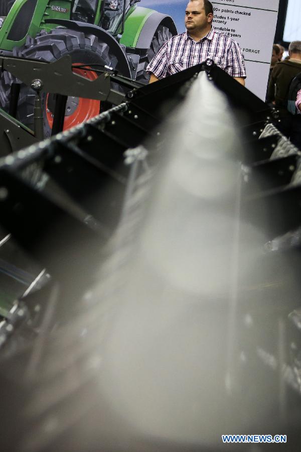A boy plays in an operator cabin of an agricultural machinery model at Massey Ferguson's stand during the 2015 Agritechnica agricultural technology fair, in Hanover, Germany, Nov. 9, 2015.