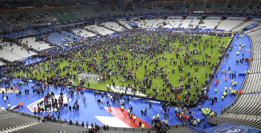 Spectators gather on the pitch of the Stade de France stadium following the friendly football match between France and Germany in Saint-Denis, north of Paris, on November 13, 2015, after a series of gun attacks occurred across Paris.