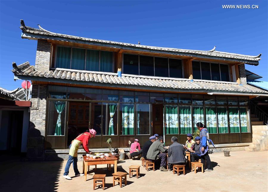 People of local Naxi ethnic group hold a family banquet at a yard in Tianhong Village, located at an altitude of around 3000 meters, in Yulong Naxi Autonomous County, southwest China's Yunnan Province, Nov. 24, 2015.