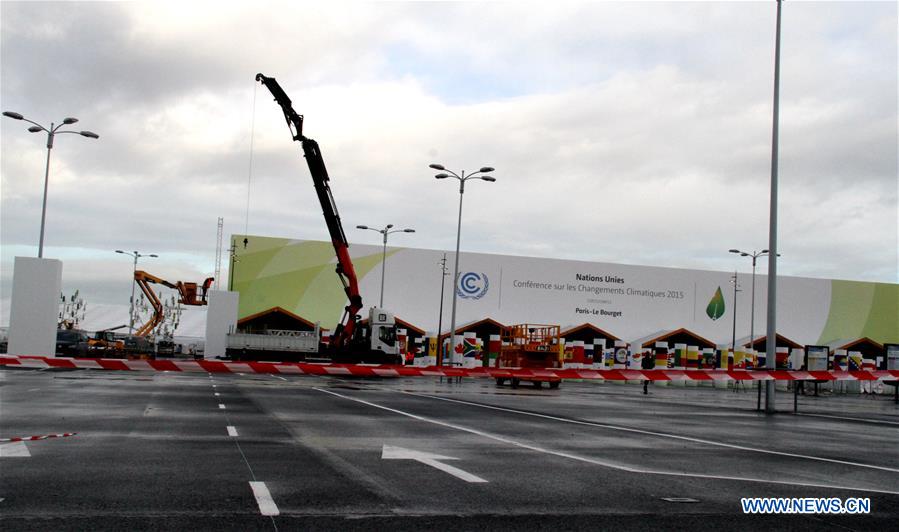 Workers work within the security lines at the entrance of Le Bourget where the 2015 United Nations Climate Change Conference (COP 21) will take place in Paris, France on Nov. 25, 2015. 