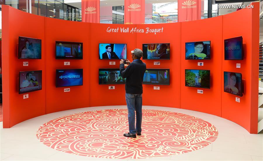 A man takes photos of the Chinese TV programs during a culture exhibition named 'Nihao China (Hello China)' held by a local TV business, in Johannesburg, South Africa, on Sept. 21, 2015. 