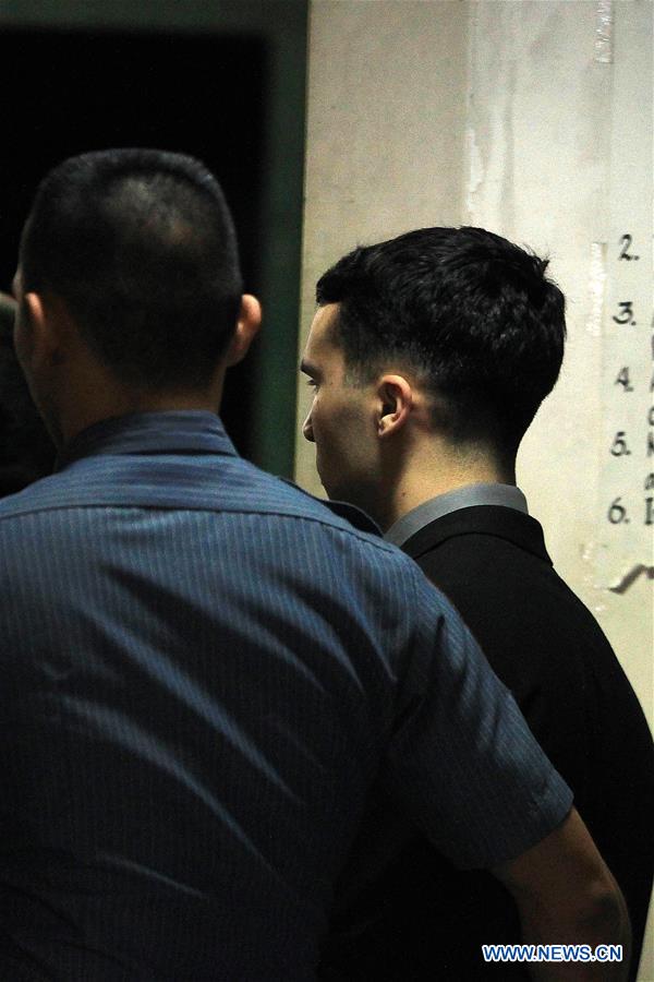 U.S. Marine Lance Corporal Joseph Scott Pemberton (R) is escorted by security personnel before the verdict on a murder case at the Regional Trial Court in Olongapo City, the Philippines, Dec. 1, 2015.