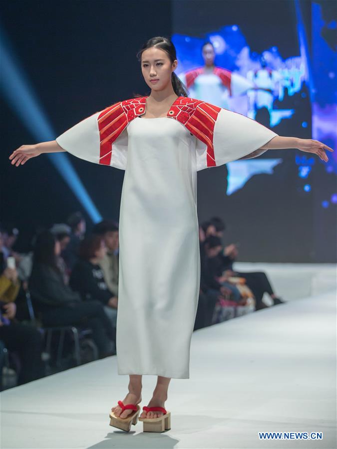 A model presents a creation designed by graduates of Beijing Institute of Fashion Technology at a fashion show in Beijing, capital of China, Dec. 1, 2015. 