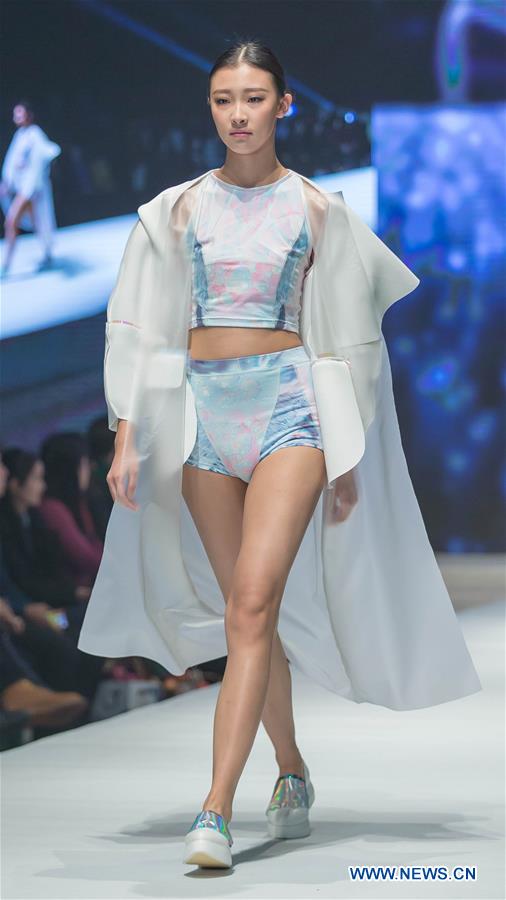 A model presents a creation designed by graduates of Beijing Institute of Fashion Technology at a fashion show in Beijing, capital of China, Dec. 1, 2015.