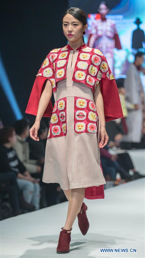 A model presents a creation designed by graduates of Beijing Institute of Fashion Technology at a fashion show in Beijing, capital of China, Dec. 1, 2015.