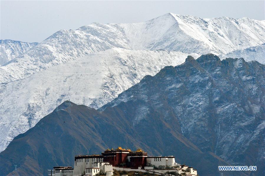 The Potala Palace is seen with snow mountains in the background, in Lhasa, capital of southwest China's Tibet Autonomous Region, Dec. 3, 2015.  