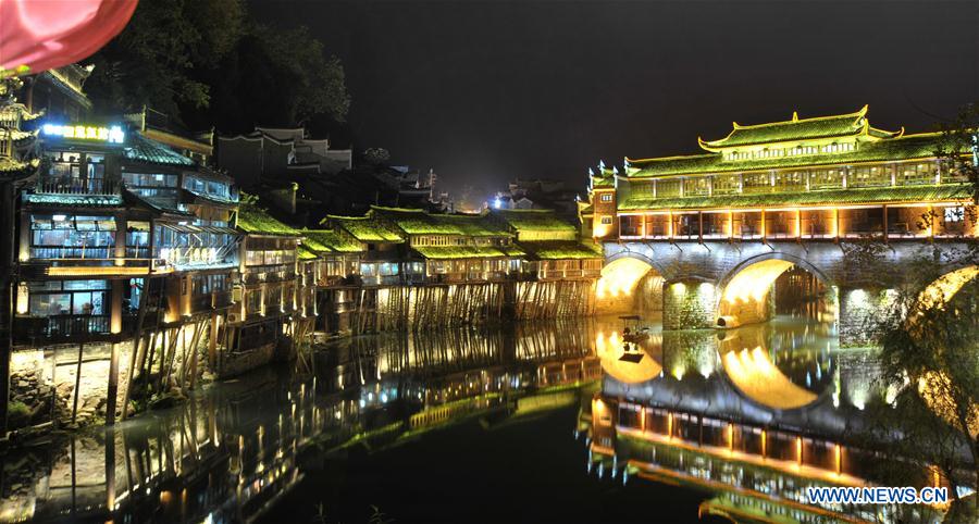 Photo taken on Nov. 29, 2015 shows the night view of the ancient town of Fenghuang in Xiangxi Tujia-Miao Autonomous Prefecture, central China's Hunan Province.  