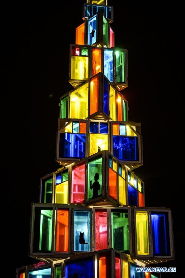 An unusual Christmas tree built by local vocational school students from used wooden window frames is lightened up in Rakvere, Estonia, Nov. 29, 2015. 