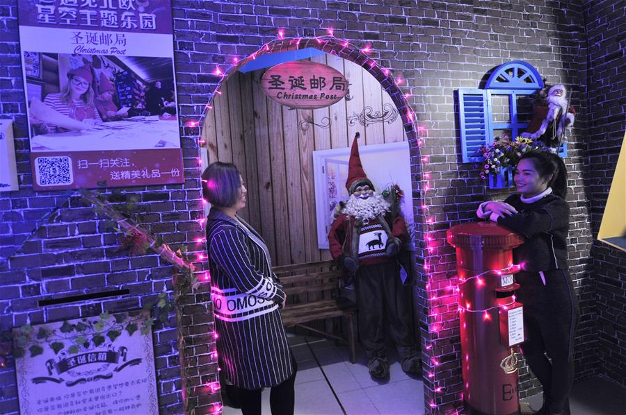 People visit a Christmas theme park at a shopping mall in Qingdao, east China's Shandong Province, Dec. 15, 2015. A Christmas theme park attracted visitors at a shopping mall in Qingdao on Tuesday. (Xinhua/Wang Haibin)