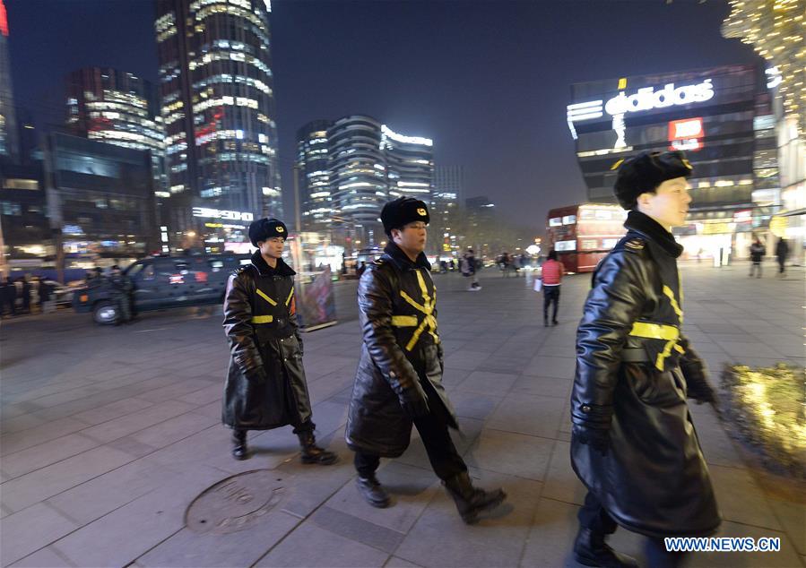 Scurity personnel patrol the popular Sanlitun area in Beijing, capital of China, Dec. 24, 2015.