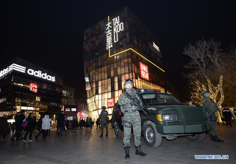 Armed police work at the popular Sanlitun area in Beijing, capital of China, Dec. 24, 2015.