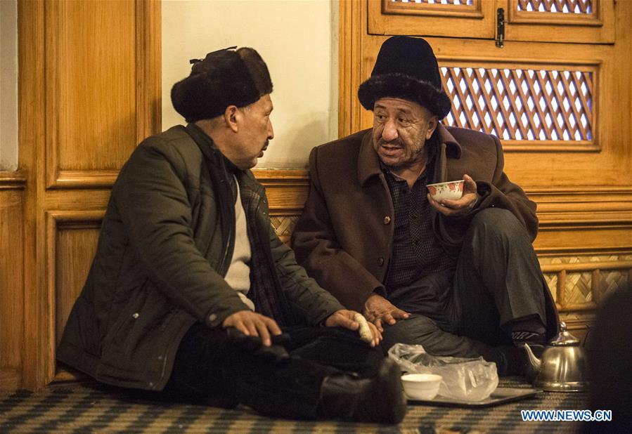 People chat at a old teahouse in the old town of Kashgar, northwest China's Xinjiang Uygur Autonomous Region, Dec. 18, 2015.