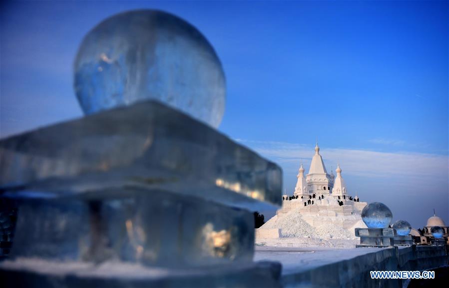 Snow sculptors work on a snow sculpture, which will be the highest in the world, in Taiyangdao, a small island in Harbin, northeast China's Heilongjiang Province, Dec. 24, 2015. 