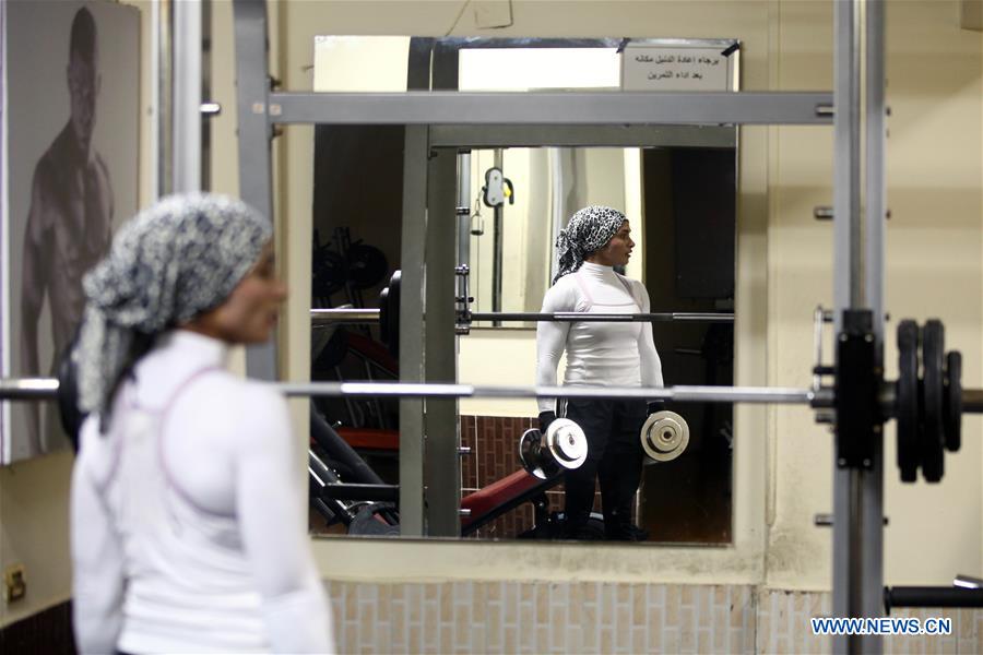 Kholoud Essam takes bodybuilding exercises at a gym in Cairo, Egypt, on Dec. 29, 2015.