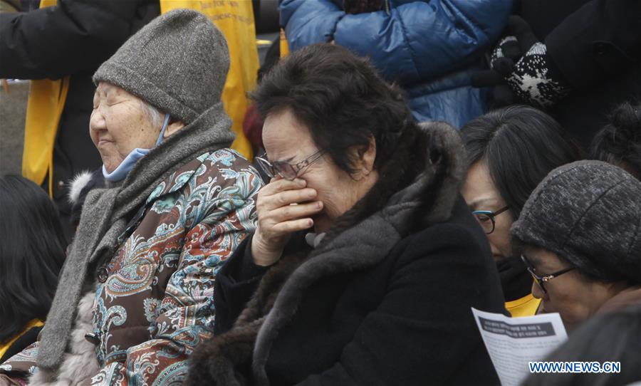 People hold portraits of deceased former South Korean 'comfort women' during a weekly anti-Japan protest in front of the Japanese embassy in Seoul, South Korea, Dec. 30, 2015. 