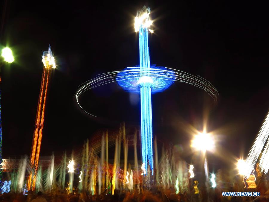 A musement park lit up with lights is seen during the celebration of the upcoming New Year's Day in downtown Baghdad, Iraq, on Dec. 31, 2015. (Xinhua/Khalil Dawood) 