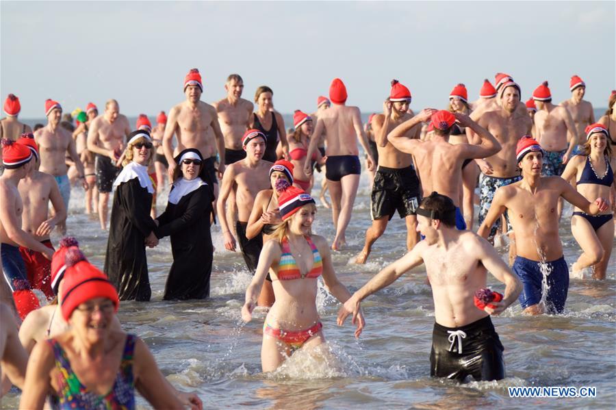 People take part in the traditional New Year's Dive event in Bolemendaal aan Zee, the Netherlands, on Jan. 1, 2016. Tens of thousands of people in the Netherlands plunge into freezing water each January to start the New Year afresh. 