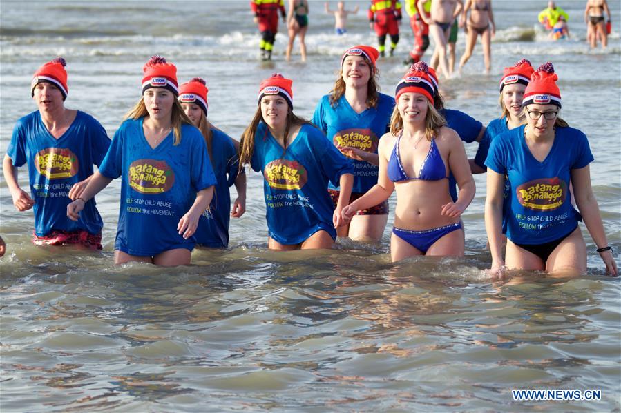 People take part in the traditional New Year's Dive event in Bolemendaal aan Zee, the Netherlands, on Jan. 1, 2016. Tens of thousands of people in the Netherlands plunge into freezing water each January to start the New Year afresh.