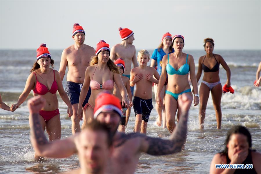 People take part in the traditional New Year's Dive event in Bolemendaal aan Zee, the Netherlands, on Jan. 1, 2016. Tens of thousands of people in the Netherlands plunge into freezing water each January to start the New Year afresh.