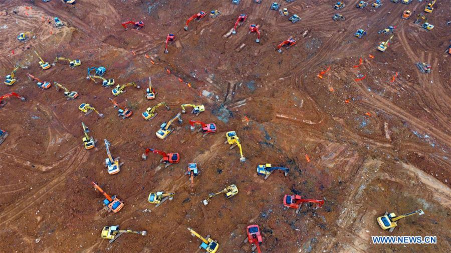 Photo taken on Dec. 28, 2015 shows excavators and bulldozers working at the landslide site at an industrial park in Shenzhen, south China's Guangdong Province. 