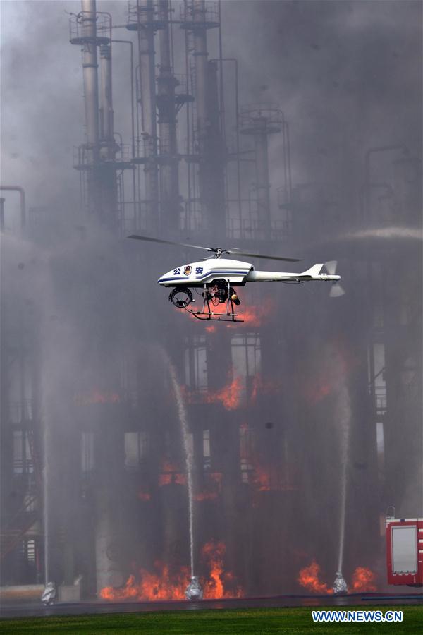 A drone monitors the fire during a drill in Shenyang, capital of northeast China's Liaoning Province, Aug. 25, 2015.