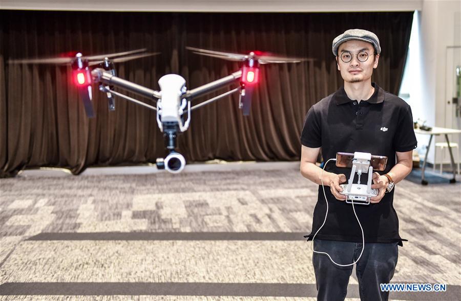 Wang Tao, founder of Da-Jiang Innovations (DJI), controls a drone in his company in Shenzhen, south China's Guangdong Province, May 22, 2015.